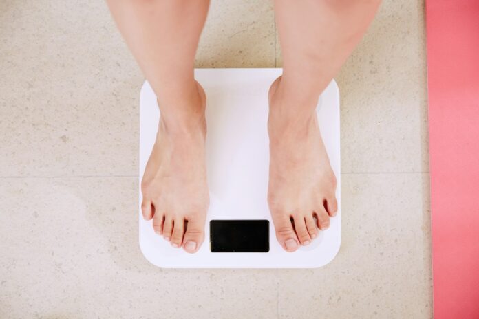 person standing on white digital weight scale
