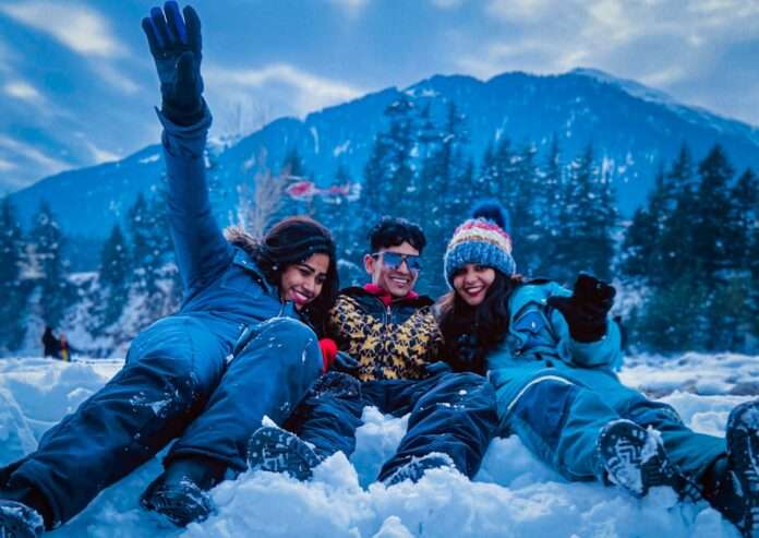3 women lying on snow covered ground during daytime