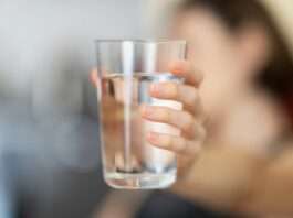 person holding clear drinking glass