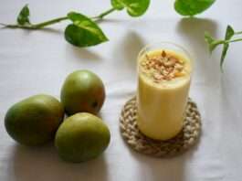 green apple beside clear drinking glass with milk