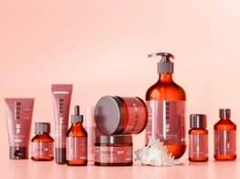 a collection of skin care products on a pink background