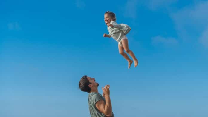 a man and a little girl flying through the air